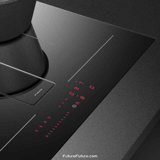 High-end induction range with downdraft hood suctioning steam from boiling green vegetables.