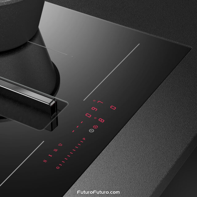 High-end induction range with downdraft hood suctioning steam from boiling green vegetables.