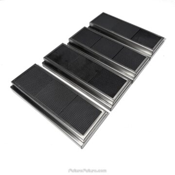 Alternate diagonal studio frame of four Portofino downdraft charcoal filter cartridges on white. Stepped metal side profiles and segmented honeycomb faces show how each cartridge seats in the cooktop filter track.