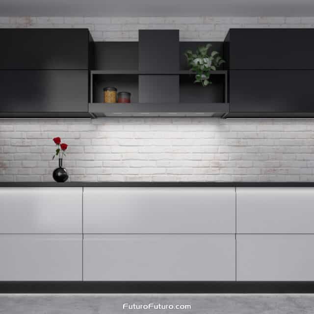 Futuro Futuro's Counter Black Wall Range Hood illuminating a kitchen with its LED lights.